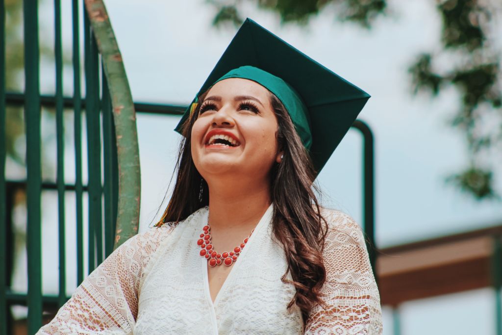 Our community college students make Women's History every day! A photo of a young woman with a graduation cap.