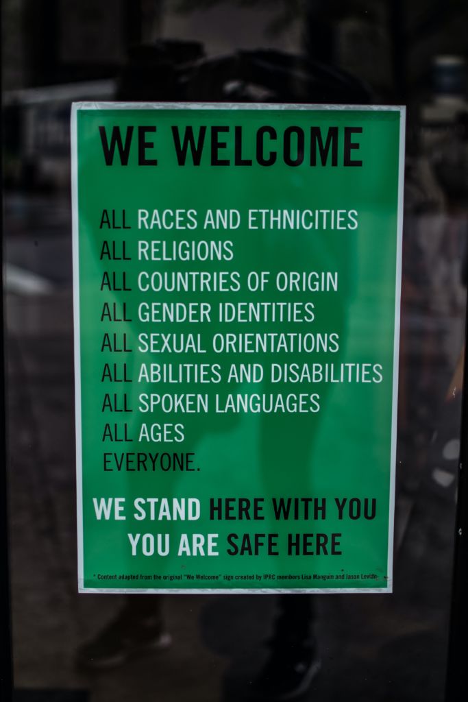 Hey sign reads, "we welcome all races in ethnicities, all religions, all countries of origin, all gender identities, all sexual orientations, all abilities and disabilities, all spoken languages, all ages, everyone. We stand here with you. You are safe here." This is a great example of beating stereotypes and advertising and beyond!