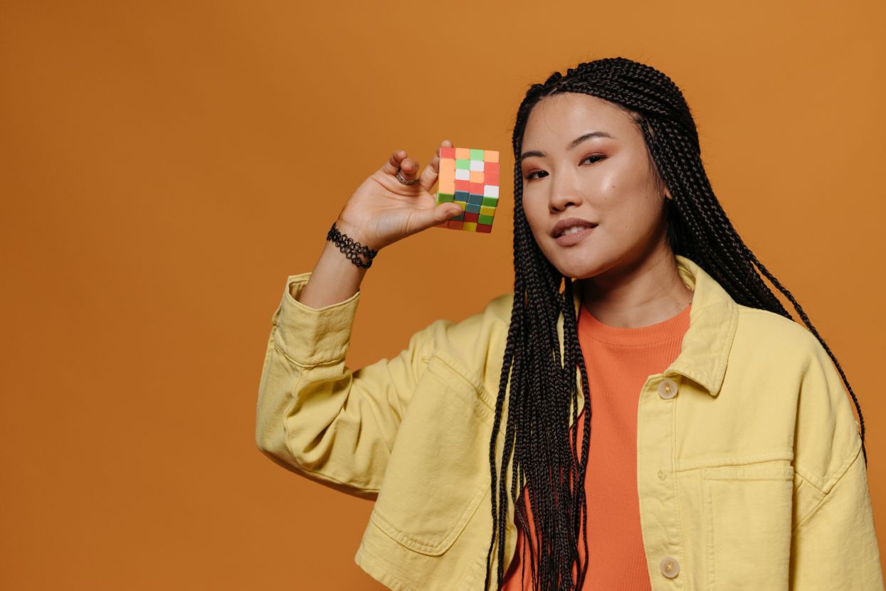 A woman holds a Rubiks cube