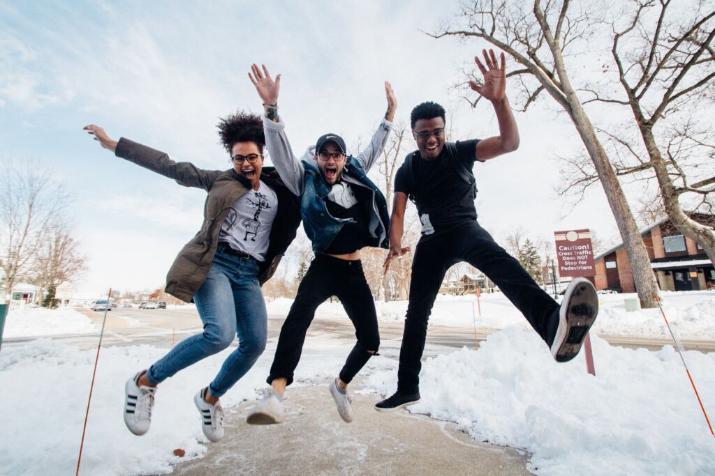 Enrollment marketing at its finest: a photo of three college students having fun on campus.