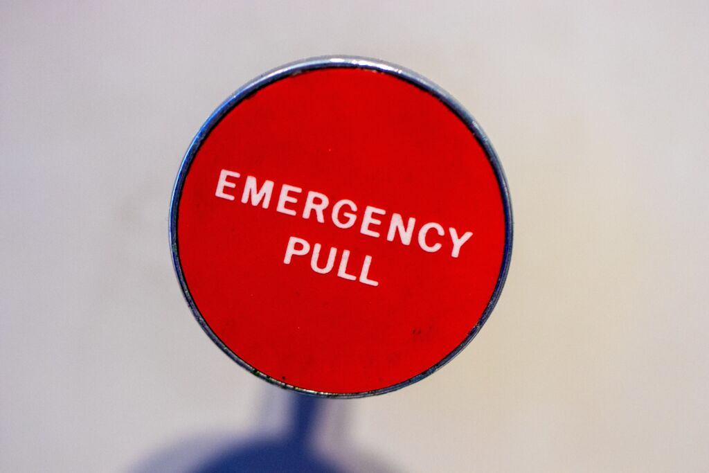 A lever reads emergency pull for crisis communication.