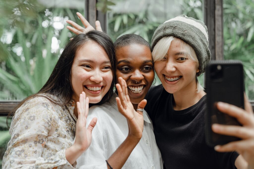 Three friends smile into a phone. Using data from our student survey, you can find out which platforms your audiences are using, from social media to TV and beyond!