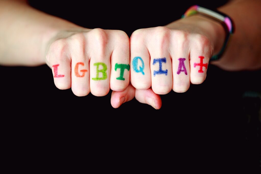 Painted on someone's fingers are the letters LGBTQIA+. When we ask What's LGBTQ? we also need to think about additional letters.