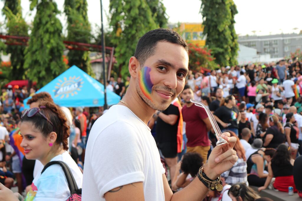 A young person with rainbow faceprint for Pride.