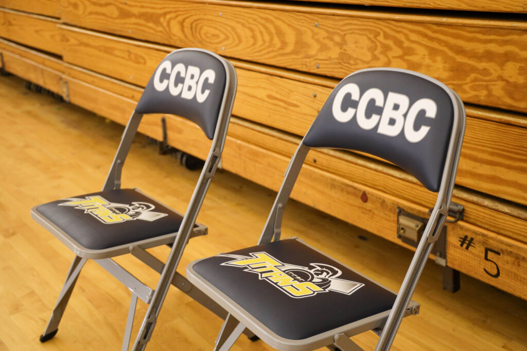 Brand strategy applies to folding chairs — CCBC puts their logo on stadium chairs to raise school spirit.