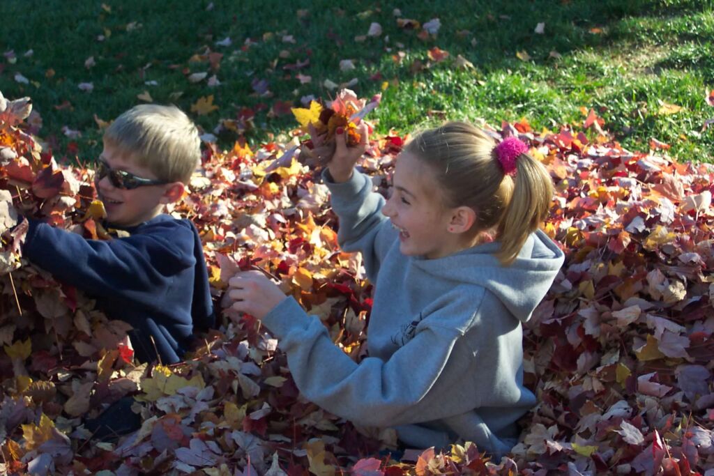 Mary is giving thanks for family memories. Photo of her kids playing in the leaves.